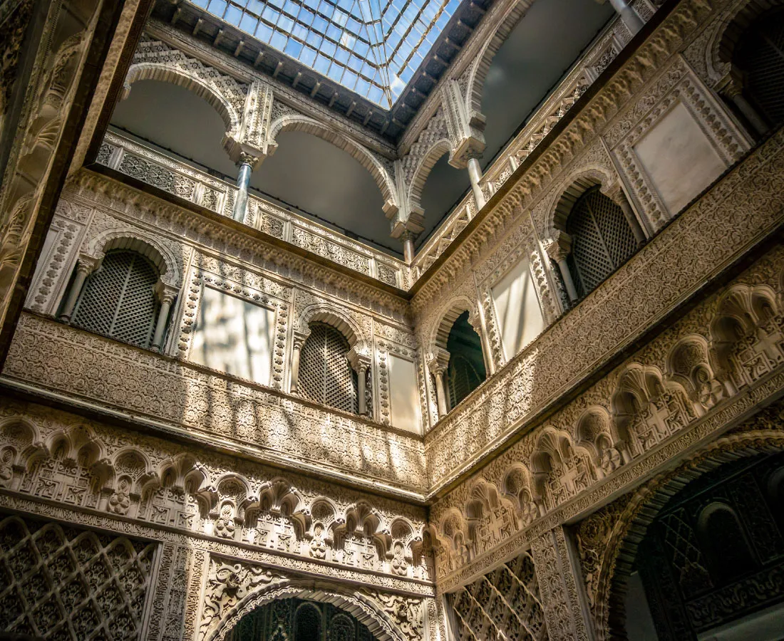 Patio con arcos y yeserías mudéjares visto desde abajo